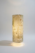 handmade cylindrical plug in lamp with tripod base and bayonet bulb.  cotton snowdrop fabric in pale green and blue table lamp with switch.  handmade lighting in made in UK. 15cm wide and 35cm tall table lamp for bedside table and cosy mood lighting.